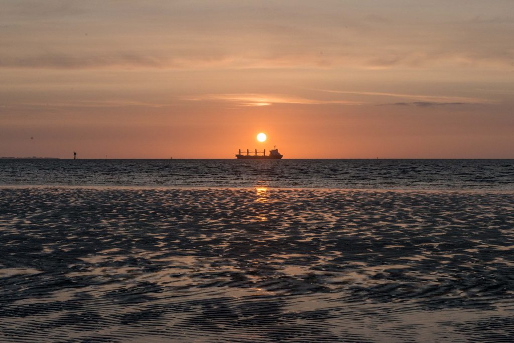 Sonnenuntergang über der Elbe bei Otterndorf mit Schiff